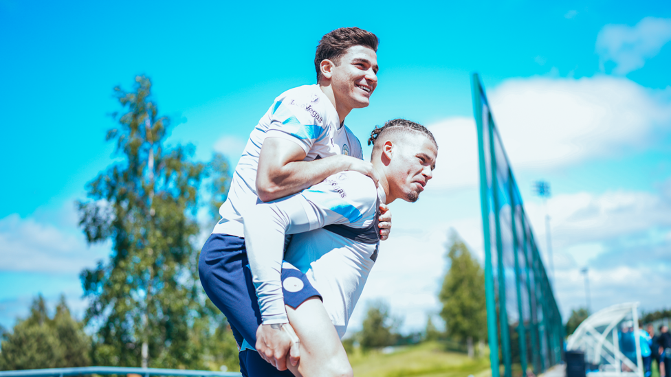 NEED A RIDE? : Kalvin Phillips makes sure Julian Alvarez isn't late to training.