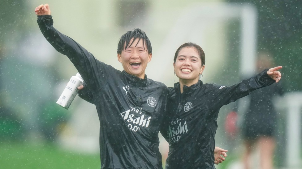 FUN IN THE...RAIN? : Japanese duo Aoba Fujino and Yui Hasegawa embrace the storm. 
