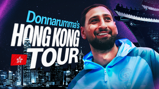 A promotional image for Donnarumma's Hong Kong tour. The text reads 'Donnarumma's Hong Kong Tour' with a Hong Kong skyline backdrop and a person wearing a blue jacket.