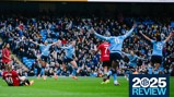 Manchester City Women's team celebrates a goal during a match against Manchester United in a crowded stadium.