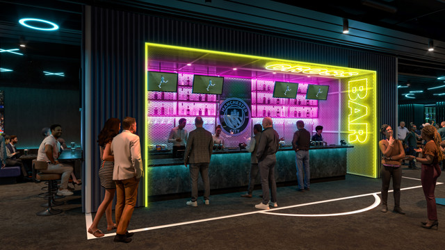 A vibrant sports bar with neon yellow and pink lighting. People are gathered at the bar watching multiple screens airing a sporting event. Manchester City logo is visible behind the bar.