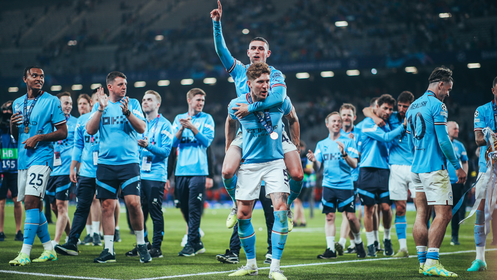 NEED A LIFT? : John Stones carries Phil Foden around while he sings