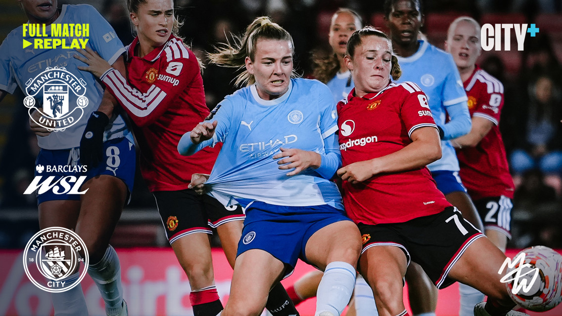 Intense action during a Women's Super League match between Manchester City and Manchester United, featuring players in blue and red kits competing for the ball.