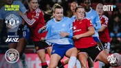 Intense action during a Women's Super League match between Manchester City and Manchester United, featuring players in blue and red kits competing for the ball.
