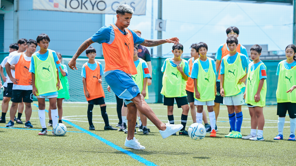 BEST FOOT FORWARD: Joao Cancelo shares some tips at the community football festival.