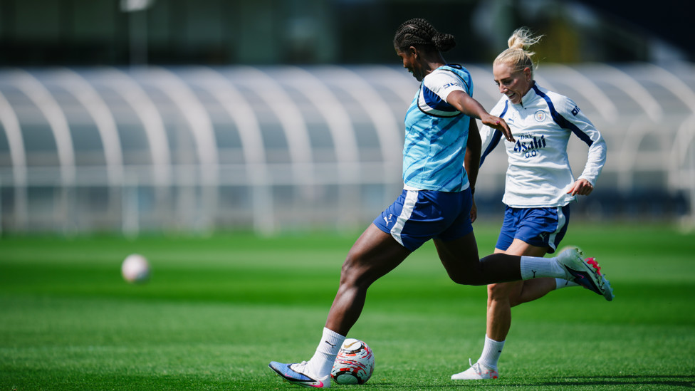 ATTACK V DEFENCE  : Bunny Shaw takes aim with Alex Greenwood applying the pressure. 