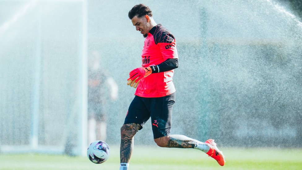 COOL OFF : Ederson avoids the sprinklers
