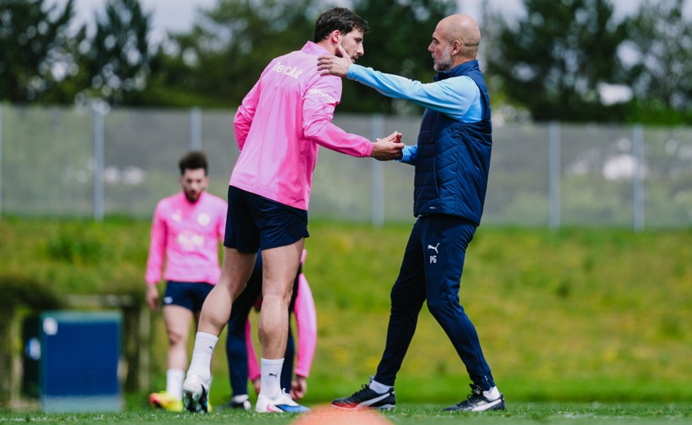 PEP TALK: The boss shares a moment with Ruben Dias.