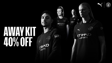Manchester City away kit promotion offering 40% off. Features players in black Puma jerseys with Etihad Airways logo on a black background.