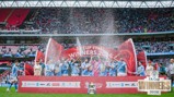 Manchester City team celebrating winning the FA Cup in 2026 at Wembley Stadium, with players raising the trophy and spraying champagne, surrounded by cheering fans in the stands.