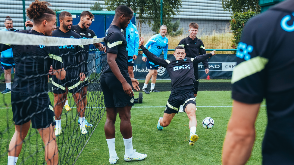 AT FULL STRETCH : Phil Foden is the centre of attention