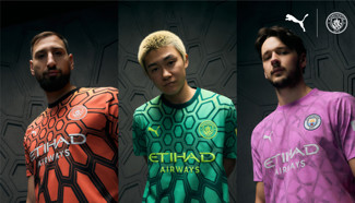 Image of three Manchester City goalkeeper kits in different colors displayed by models. The kits are branded with Puma and Etihad Airways logos.
