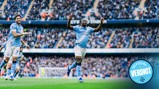 Manchester City players celebrating a goal at Etihad Stadium. A blue badge reading 'Official Verdict' is visible.