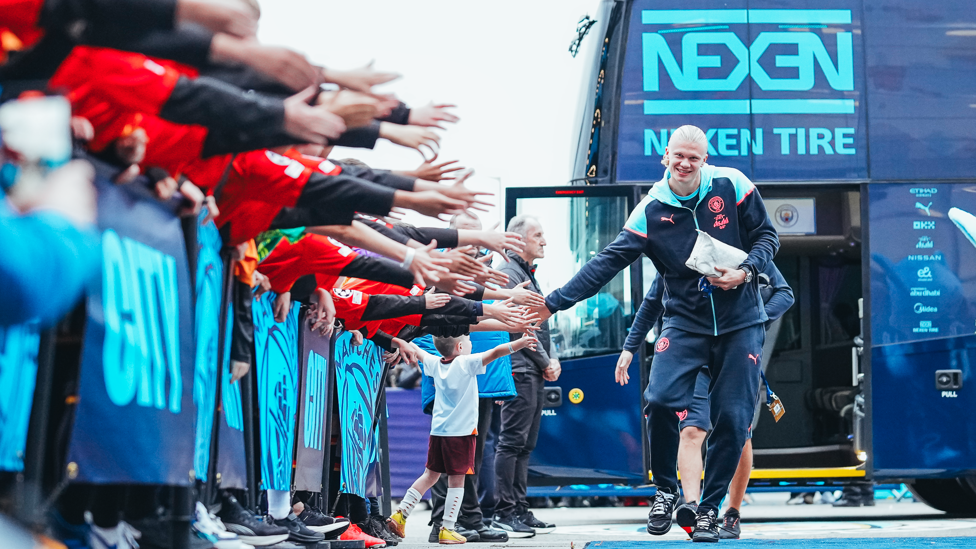 HAALAND HIGH-FIVE : Erling greets the fans on his way into the Etihad.