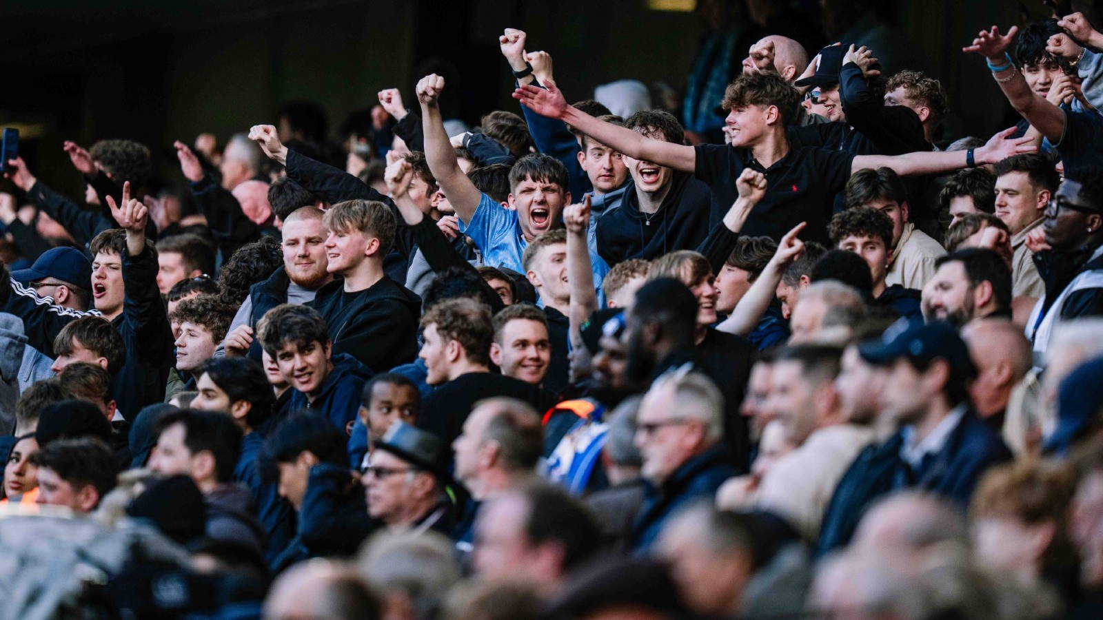 Man City fans celebrate a goal against Chelsea in Premier League clash at Stamford Bridge