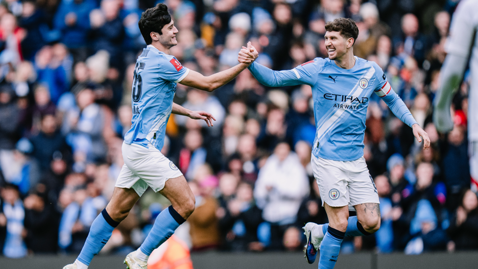 DEFENSIVE DUO : Stones and Khusanov celebrate.