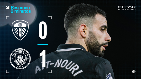 Scoreboard showing Leeds United 0 and Manchester City 1. A blurred face with 'Ait-Nouri' on the back of the shirt is visible.