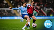 Two women soccer players from Manchester City and Manchester United in action during a match.