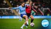 Two women soccer players from Manchester City and Manchester United in action during a match.