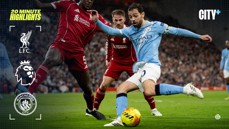 Action shot from a Premier League match between Liverpool FC and Manchester City FC, featuring intense player interactions and logos of the clubs. Includes Premier League logo and branding for City+.