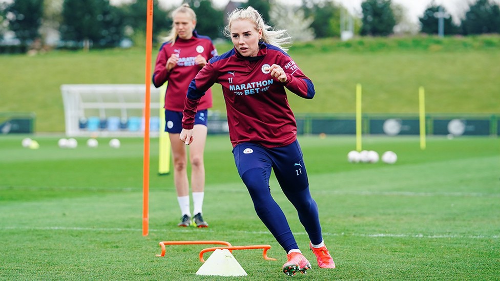 CONE ON CITY : The team take it in turns to go through the cones to get ready for the session.