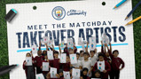 Group of children holding up art drawings with Manchester City and City in the Community logos.