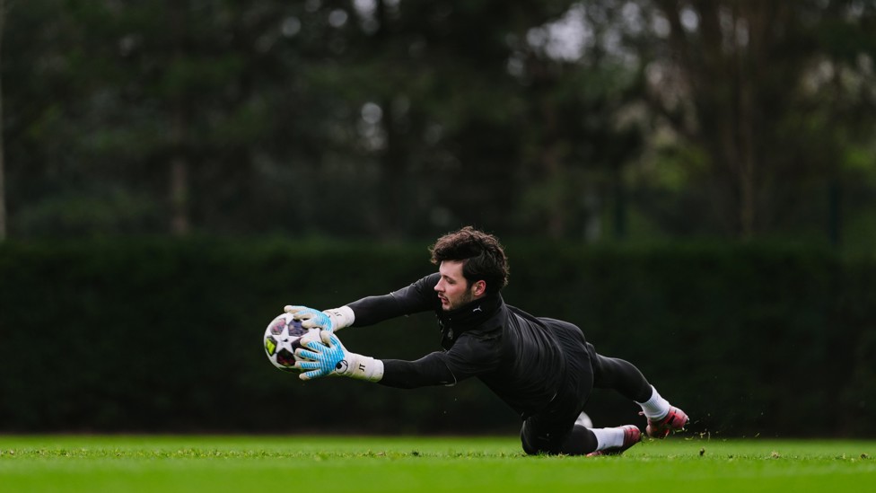 WELL HELD : James Trafford gets both hands to it