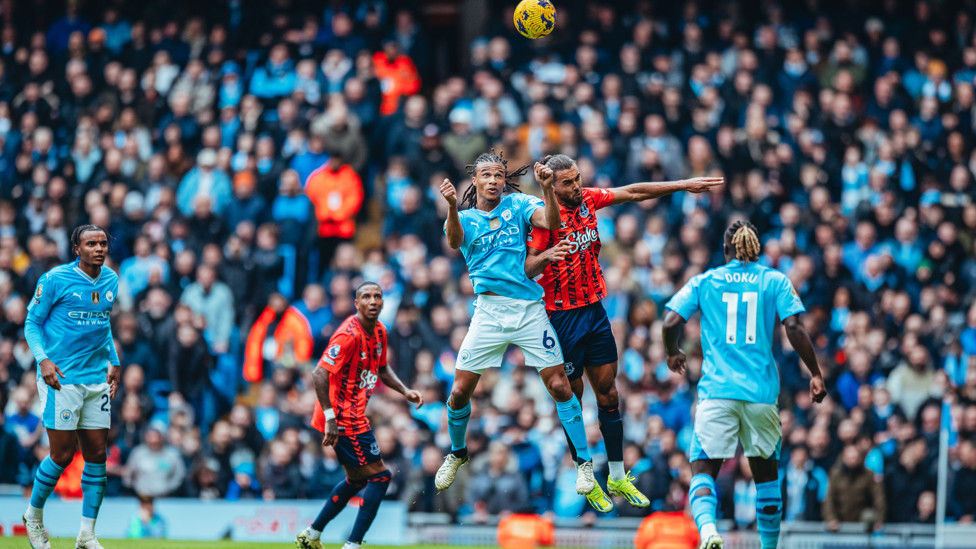 HEAD-AKE : Nathan rises high to win the header.