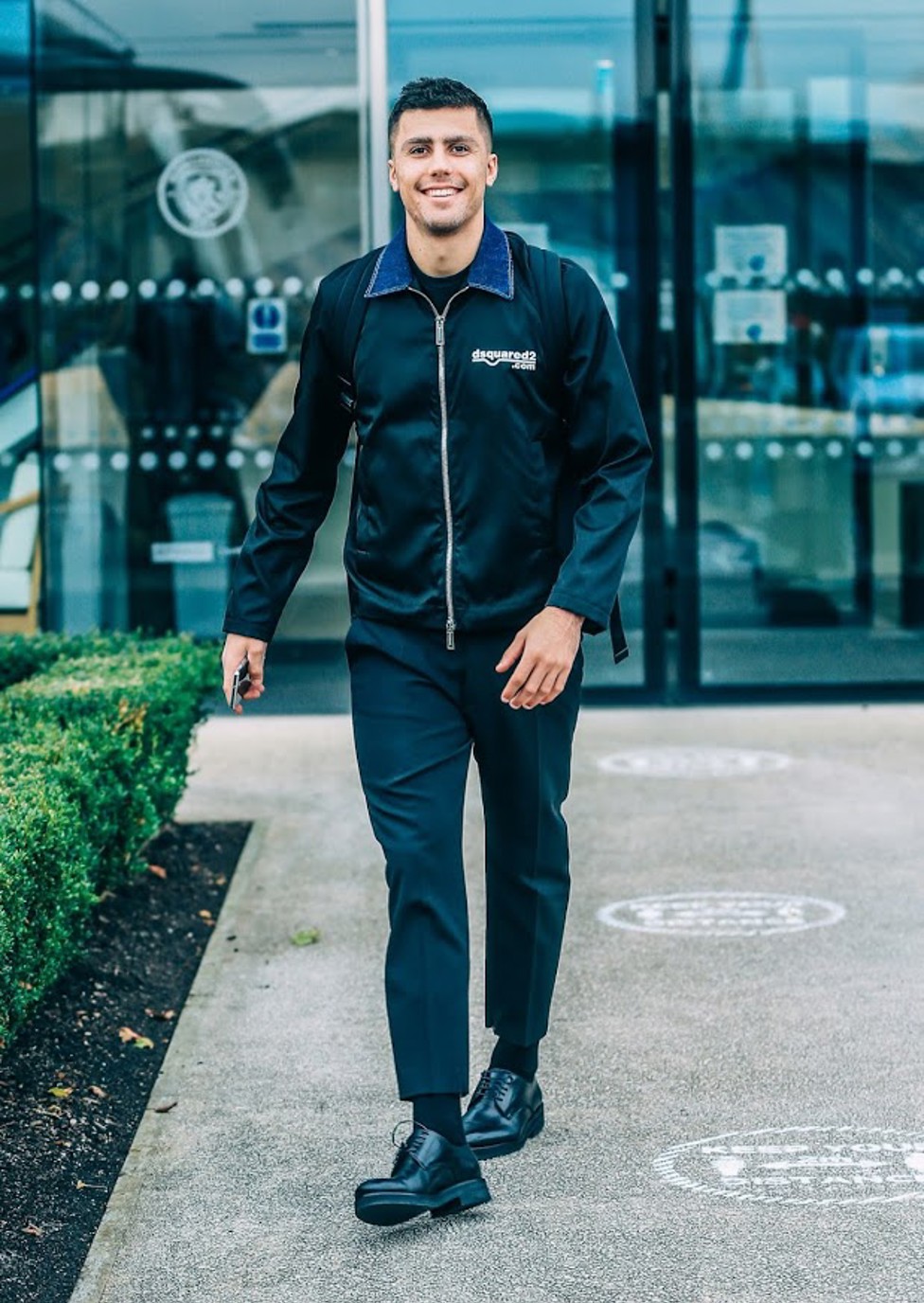 SHARP DRESSED MAN: Rodrigo was all smiles ahead of the flight to Athens