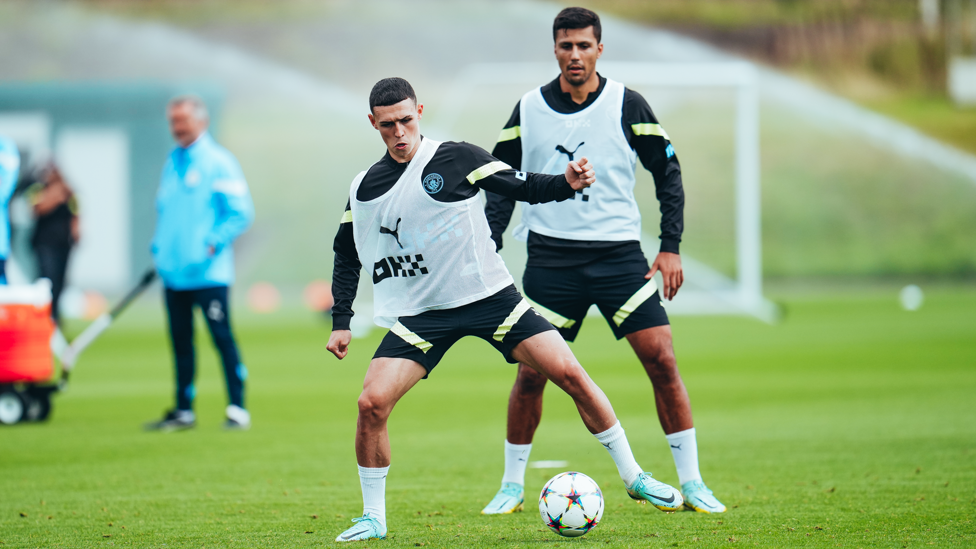 Phil Foden under the watchful eye of Rodrigo