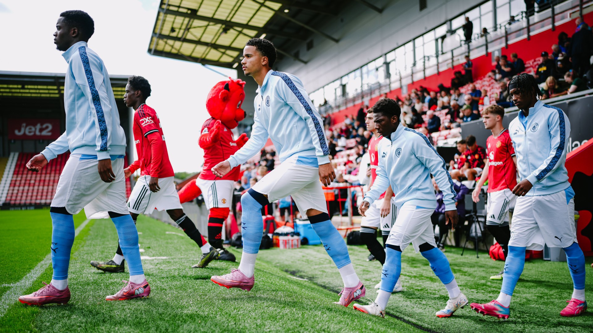 READY FOR ACTION : The team head out onto the pitch at Leigh Sports Village.