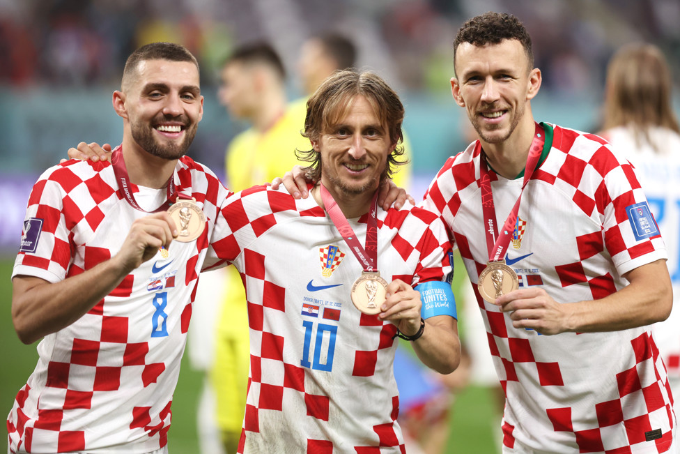 THE MEDAL MAN : The Croatian international is pictured with Luka Modric and Ivan Perisic after they win third place medals in the 2022 World Cup