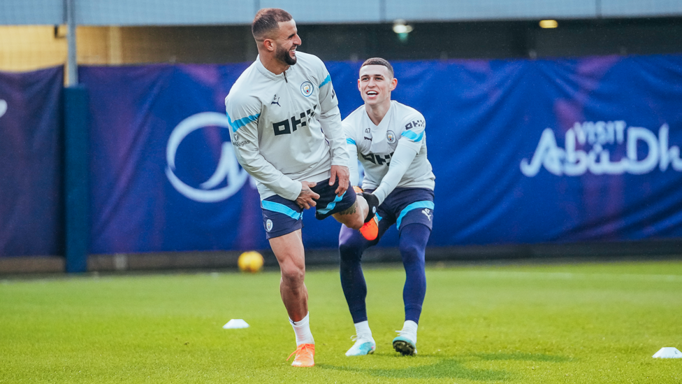 PULLING YOUR LEG : Phil Foden helps Kyle Walker with his stretches