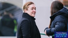 A person with short brown hair wearing a black coat is looking off to the side. Another person in a dark blue jacket is nearby. The text 'Therese Sjögran Summer Review' is visible.