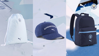 A collection of Manchester City merchandise including a drawstring bag, a cap, and a backpack. Each item features the club's emblem and the Puma logo.