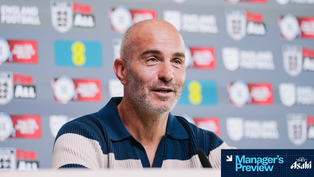 A man, likely a manager, speaking at a press conference with an England Football backdrop and various sponsors logos.