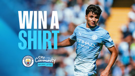 Image promoting a shirt giveaway by Manchester City with text 'WIN A SHIRT' and logos of Manchester City and City in the Community Matchday Lottery.