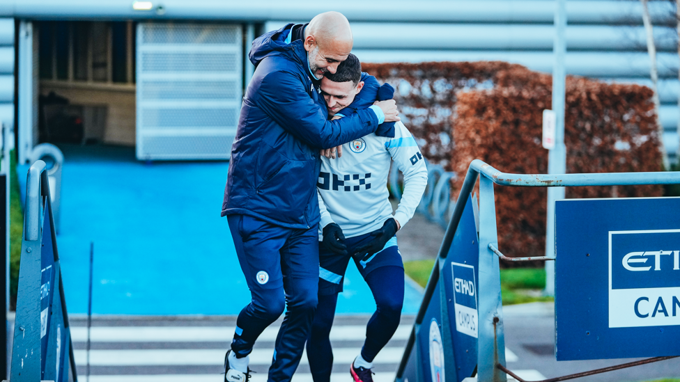 WELCOME HOME : Phil Foden gets a big hug from Pep