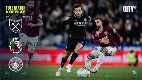 Action shot from a Premier League match between West Ham United and Manchester City. Players from both teams are in motion, competing for the ball.