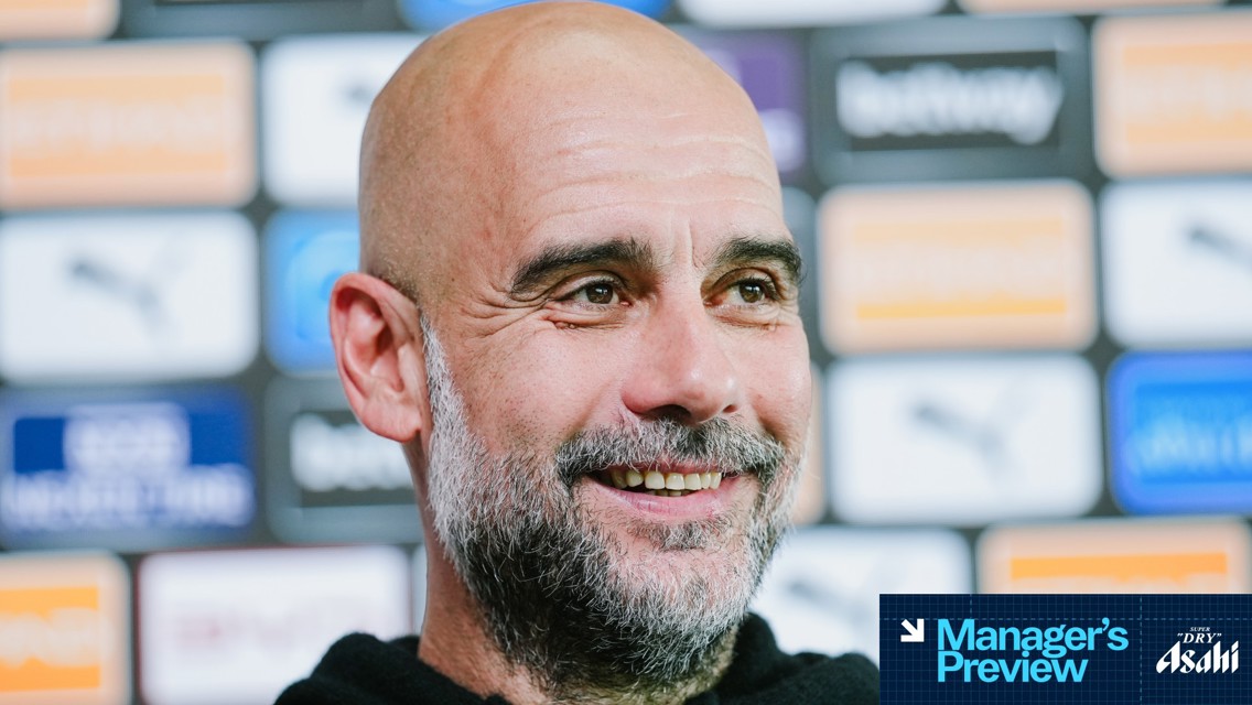 A blurred image of a person's face in a press conference setting with branded backgrounds and 'Manager's Preview' text in the corner.