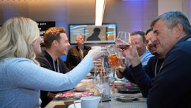 Multiple glasses of champagne arranged on a tray in a bright, modern setting, suggesting a celebratory or formal event.