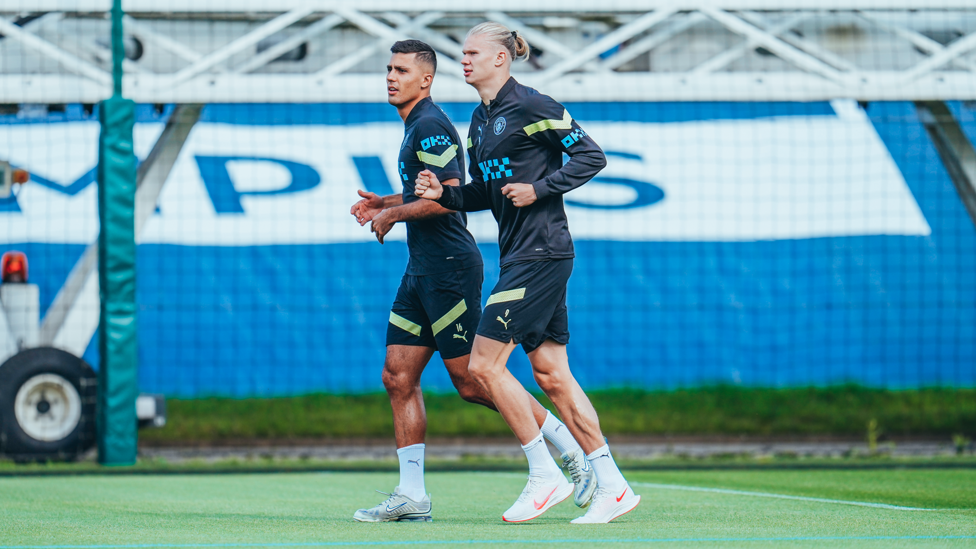 CENTRAL FIGURES : Rodrigo and Erling Haaland have a light jog around the pitch