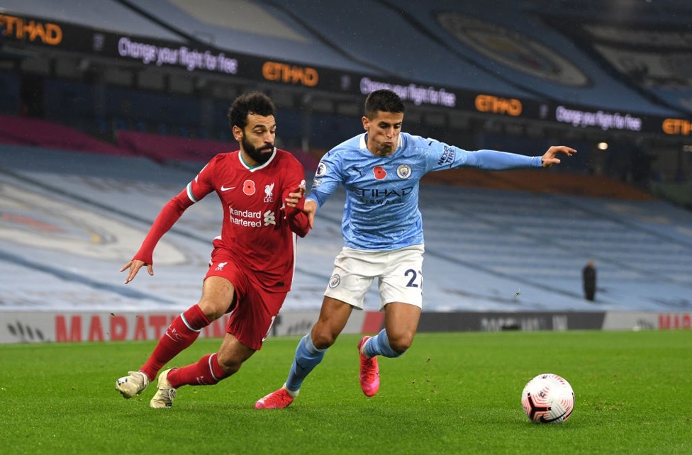 BERGERAK MAJU: Joao Cancelo bertarung melawan Liverpool