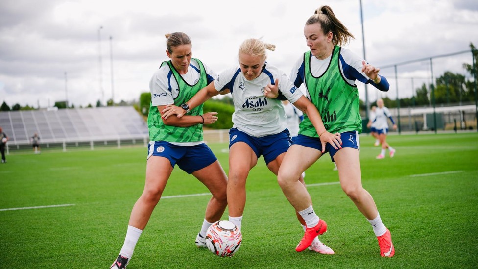 BATTLE  : Mayzee Davies shields the ball from Clinton and Lauren Hemp.