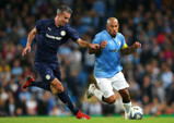 Nigel De Jong takes on Robin Van Persie at Vincent Kompany's testimonial.