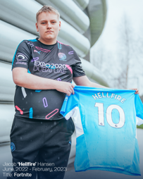 Person holding a jersey with 'Hellfire' and number 10. Wearing a black Esports jersey with Expo 2020 Dubai UAE branding.