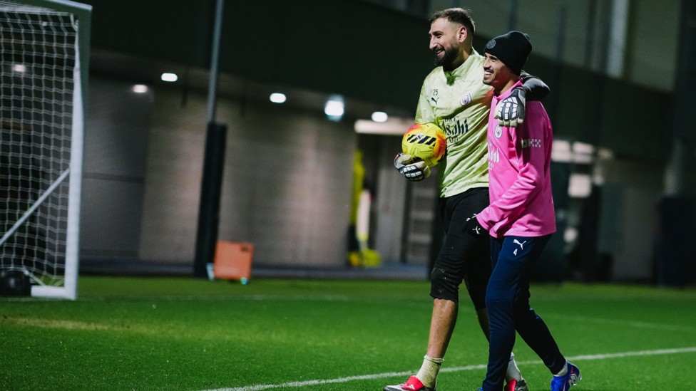 BEAR HUG : Gianluigi Donnarumma wraps his arm around Reijnders