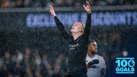 Erling Haaland celebrating under rain after achieving 100 goals in the Premier League for Manchester City, with a logo and text indicating the milestone.