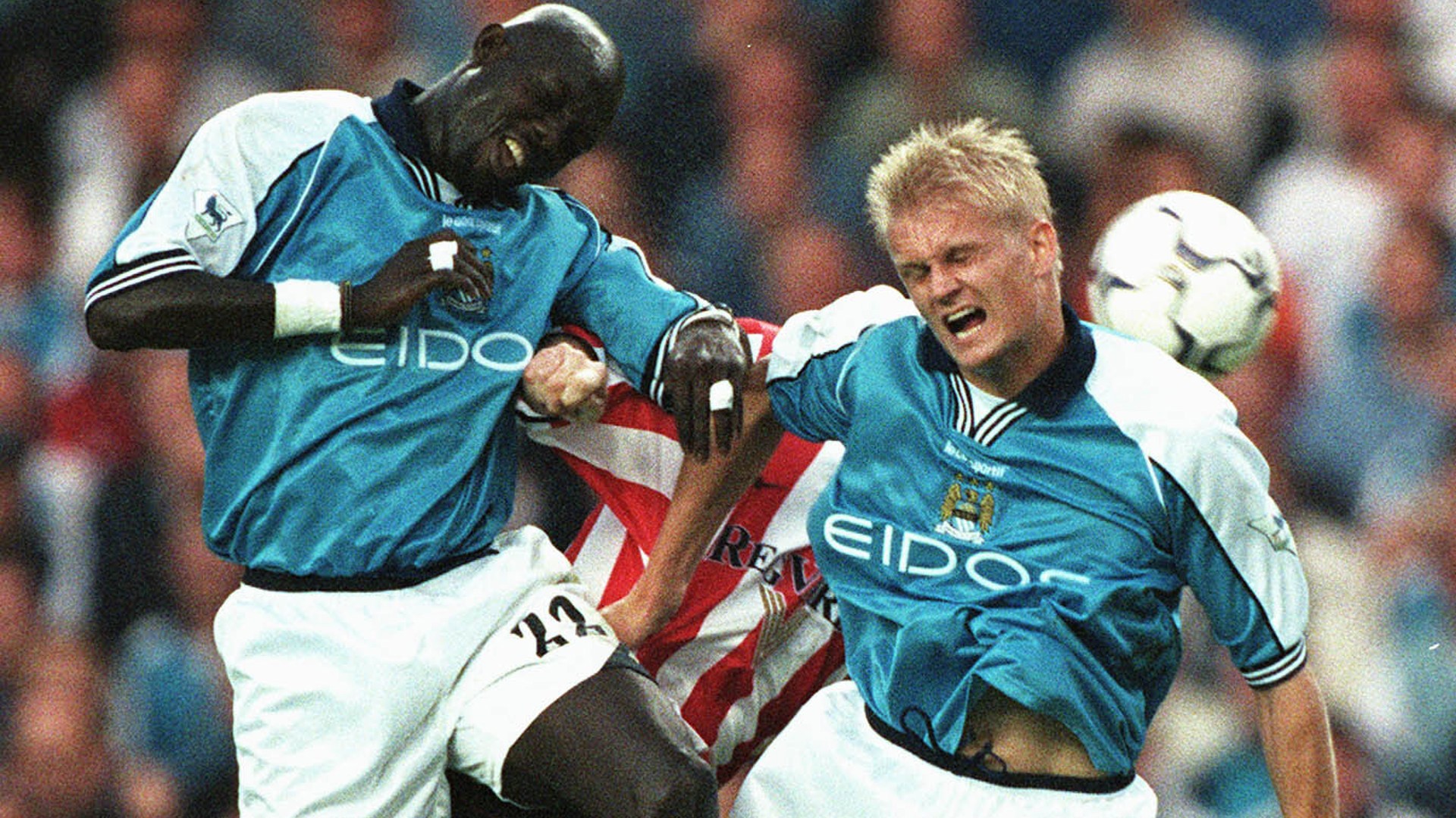 UP AND AT 'EM: George Weah in action for City alongside Alf-Inge Haaland.