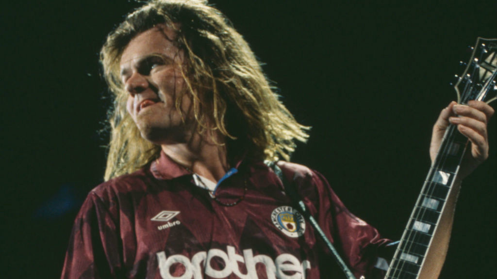 TRUE COLOURS : Billy on stage with the Cult wearing a City shirt